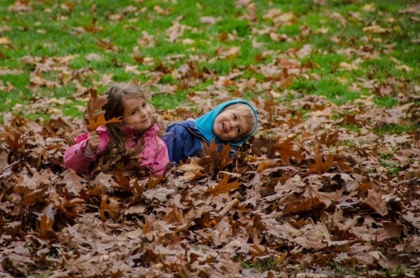 children in autumn leaves in Central Park